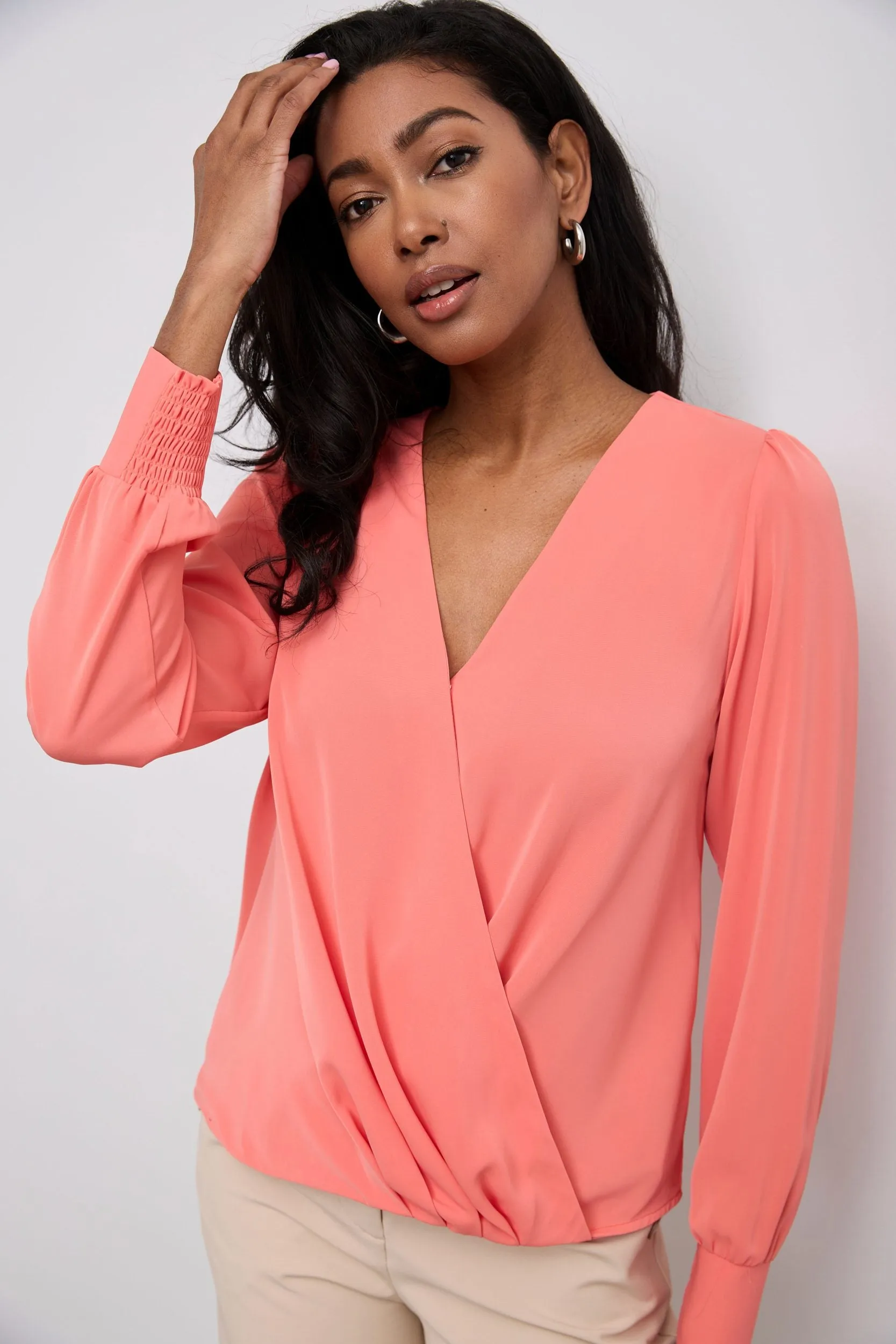 Long-sleeved blouse with a draped front