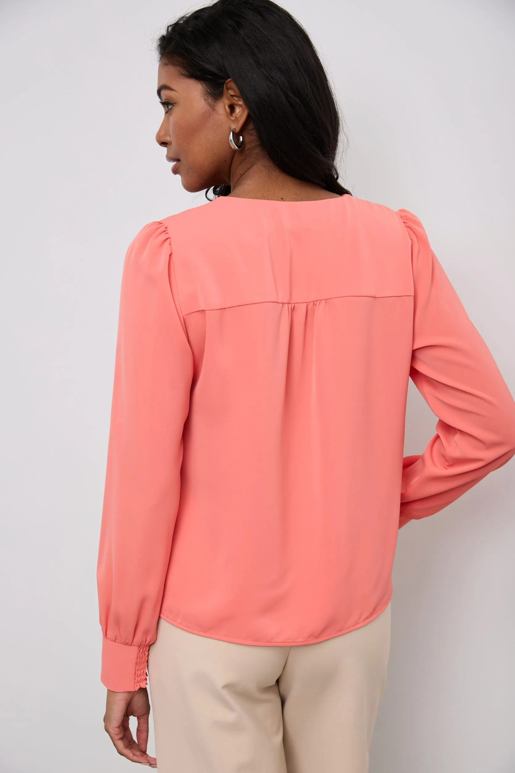 Long-sleeved blouse with a draped front