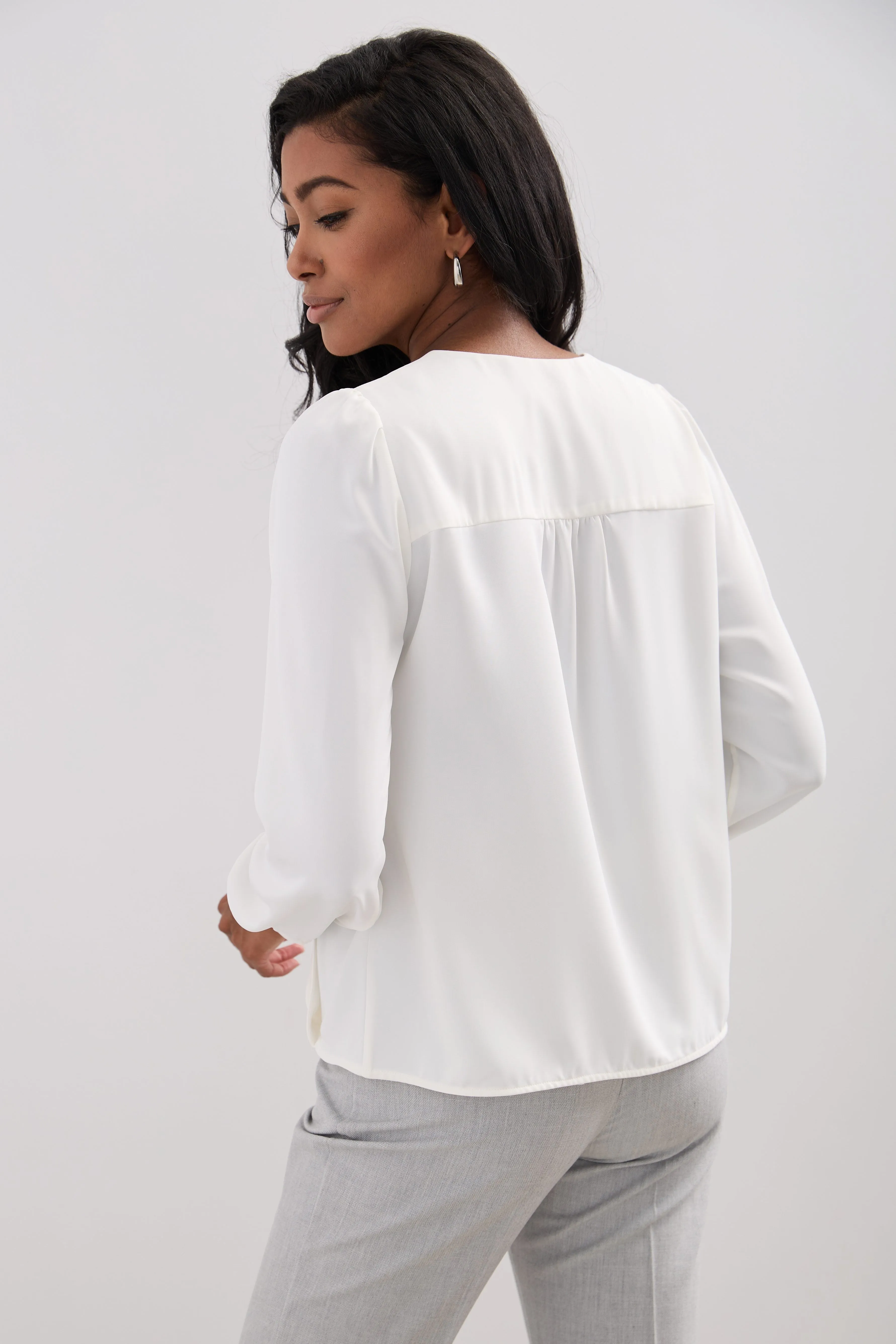 Long-sleeved blouse with a draped front